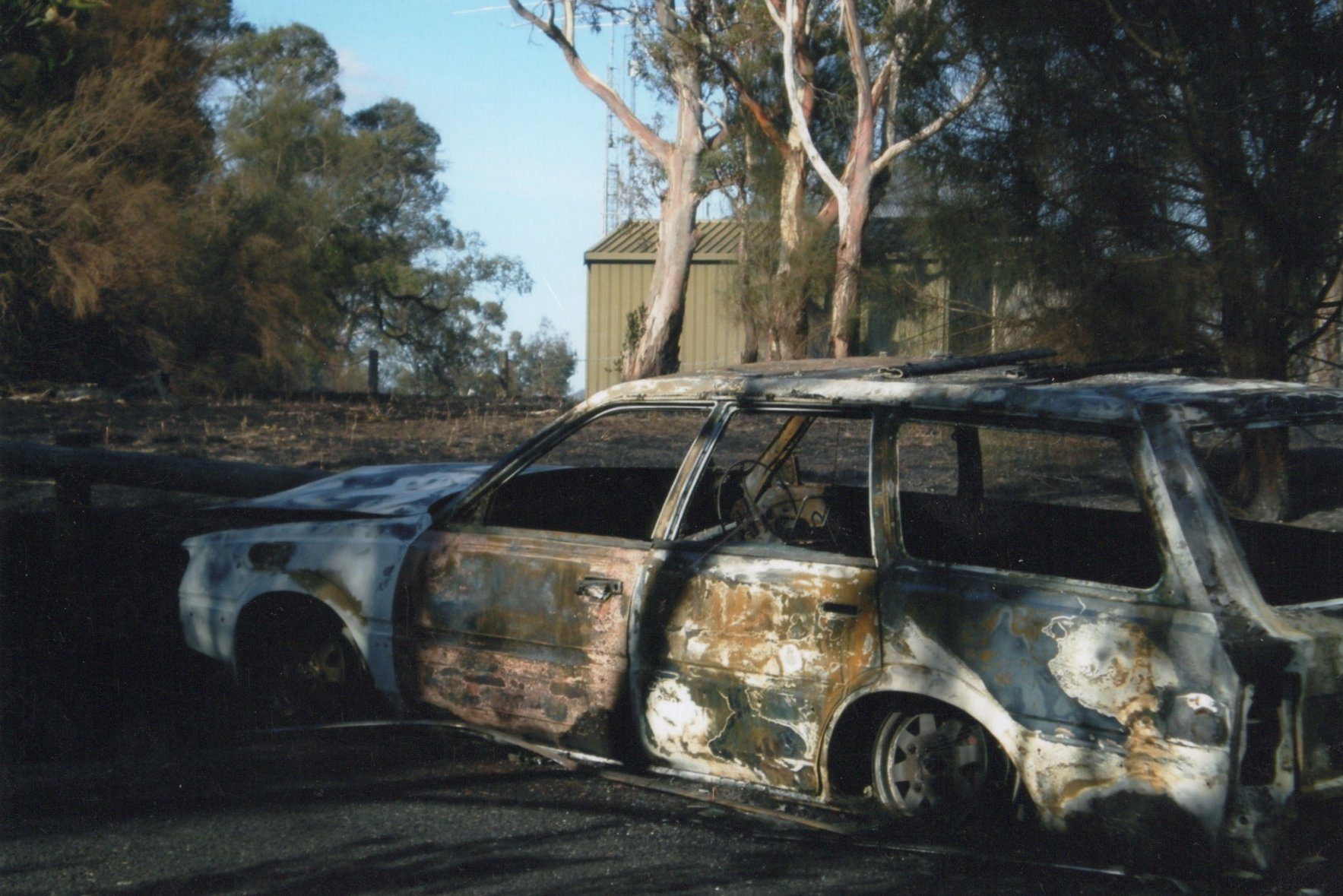 Torched car and grass fire